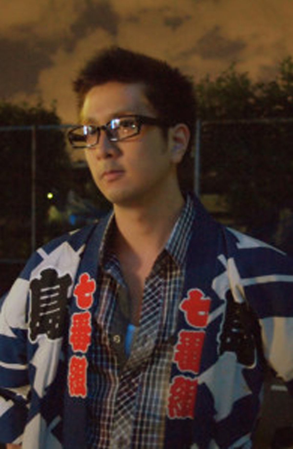 Portrait of DigiPen alumnus Mike Susetyo wearing a jacket with Japanese characters on it