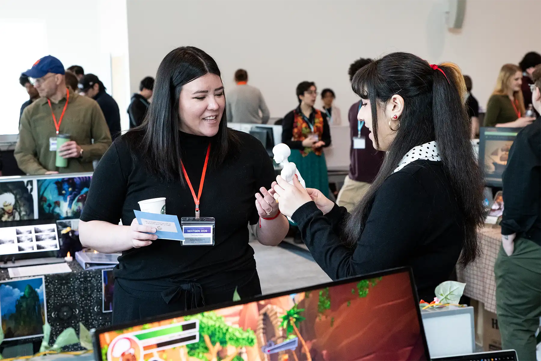A student shows a 3D printed human figure to an
industry mentor.