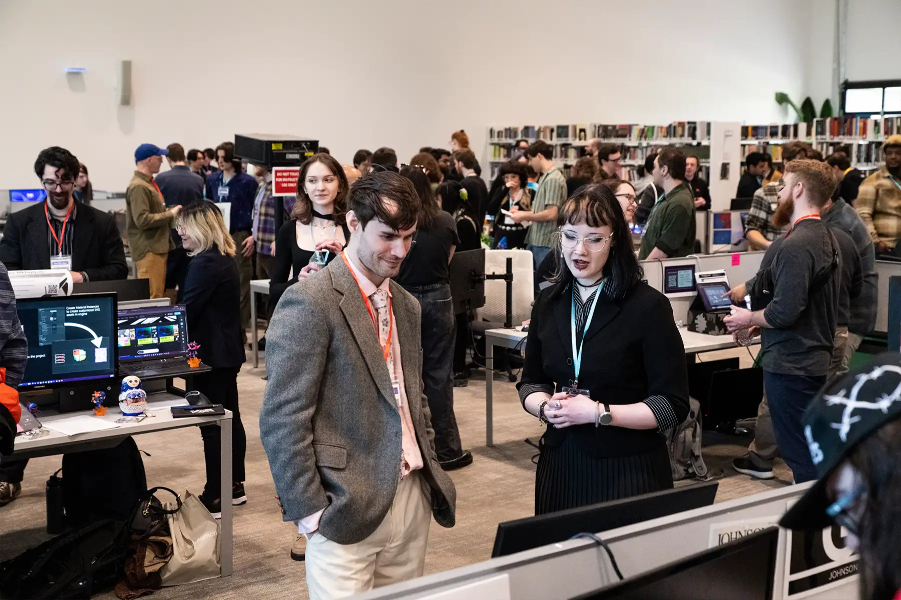 An industry mentor looks on at a computer screen as a
student talks through her project with him.