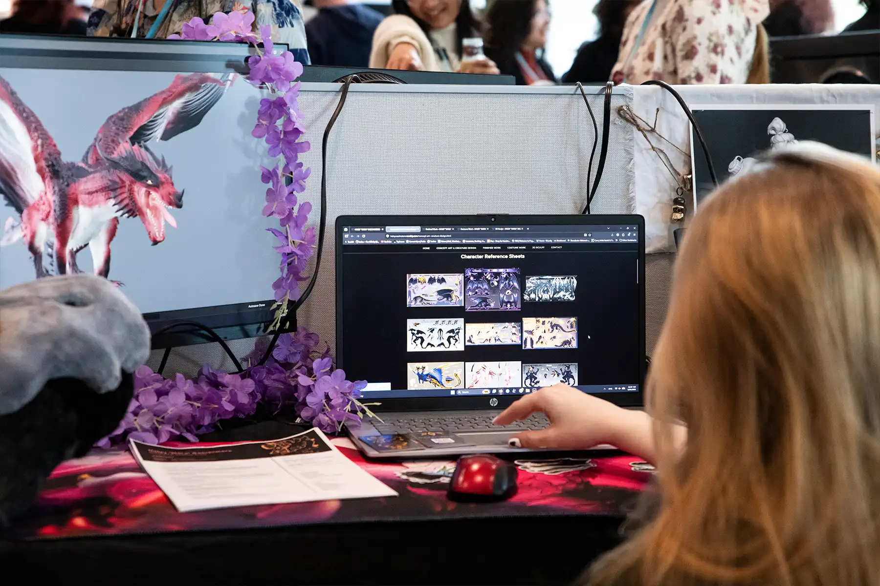 A student at NextGen sits in front of screens displaying
their projects, including a realistic 3D dragon model.