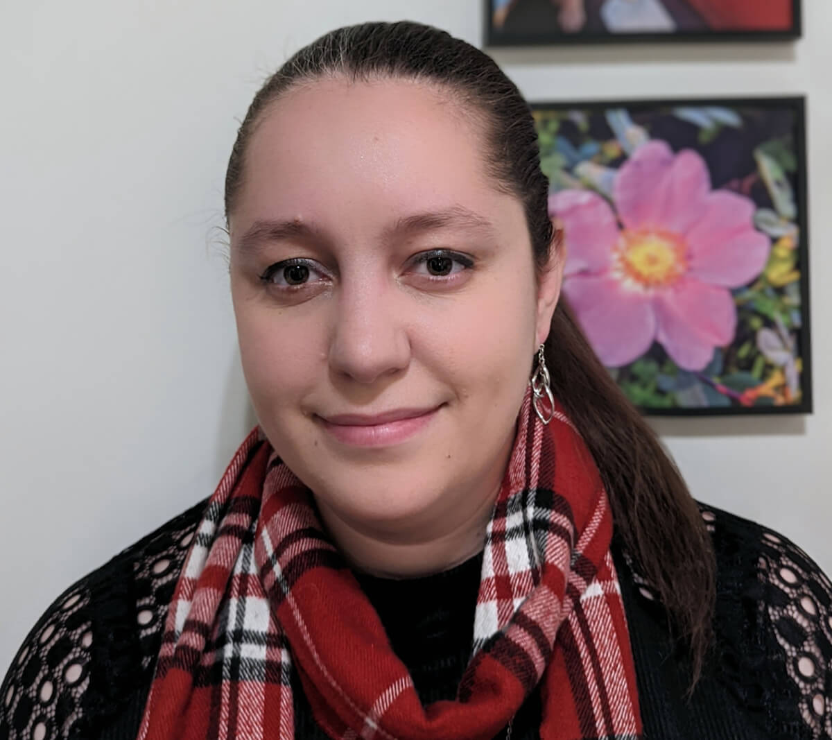 Photograph of alumnus Juli Gregg wearing a red checkered scarf