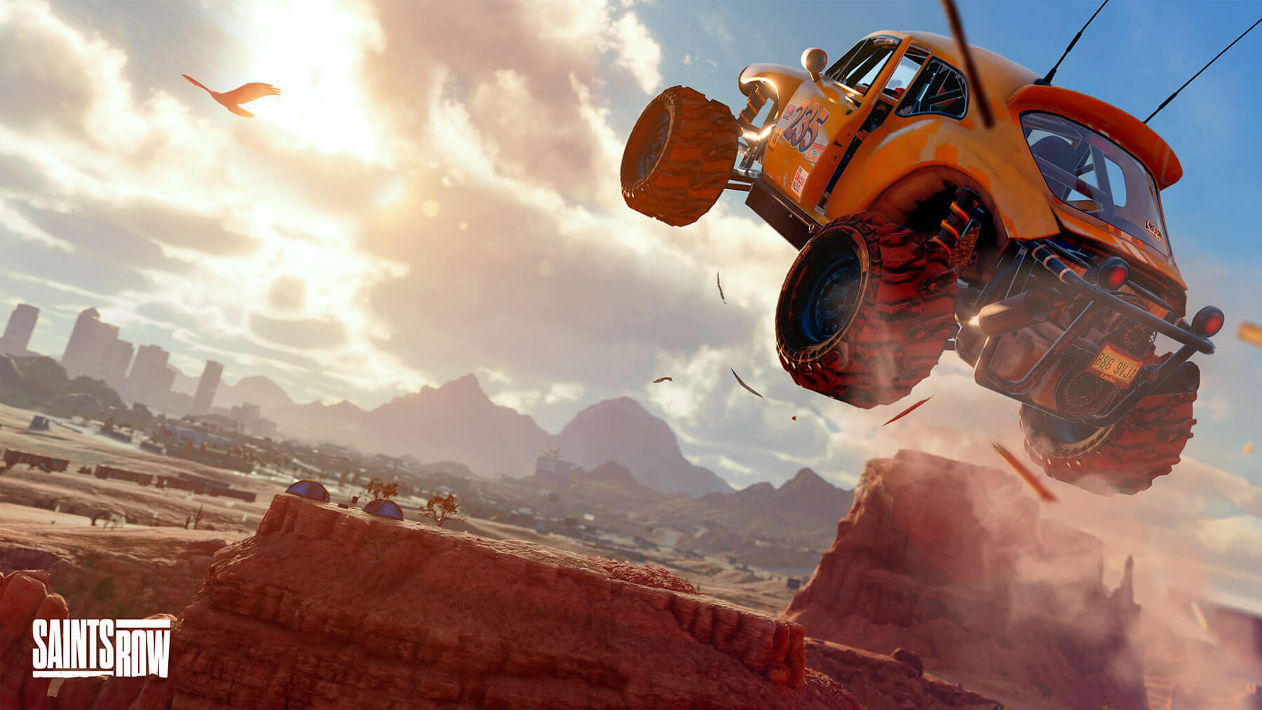 A modified yellow dune buggy launches across a vast canyon.