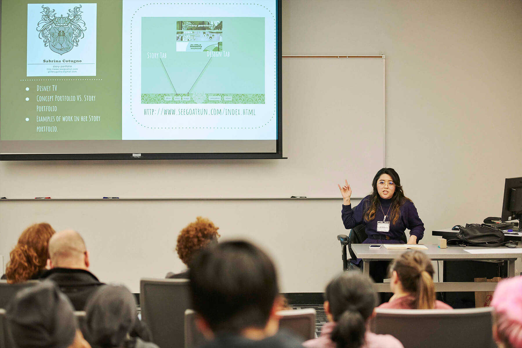 Sarah Amburgey points at a screen in a lecture hall.