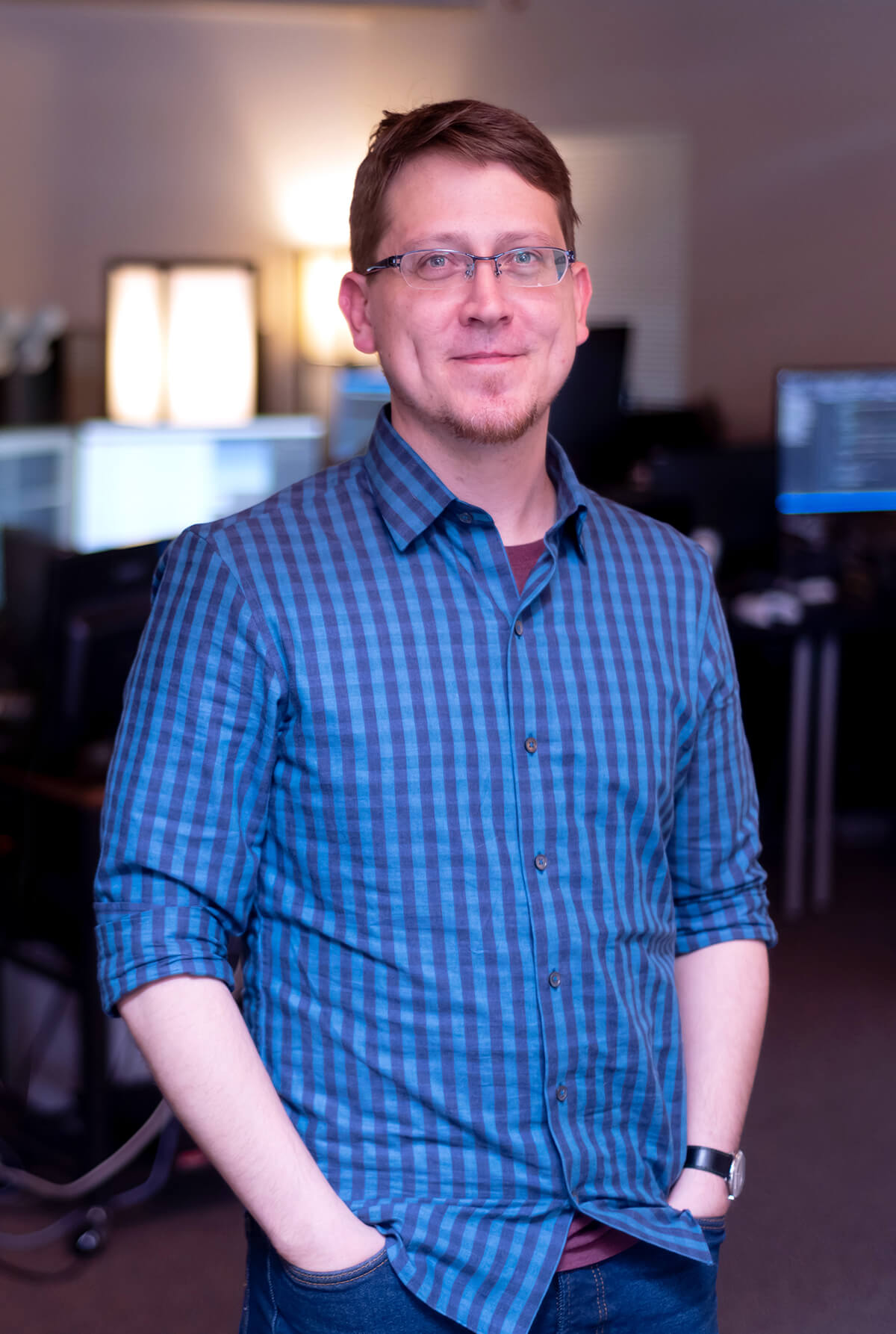 Thomas O'Connor in front of a row of computer workstations