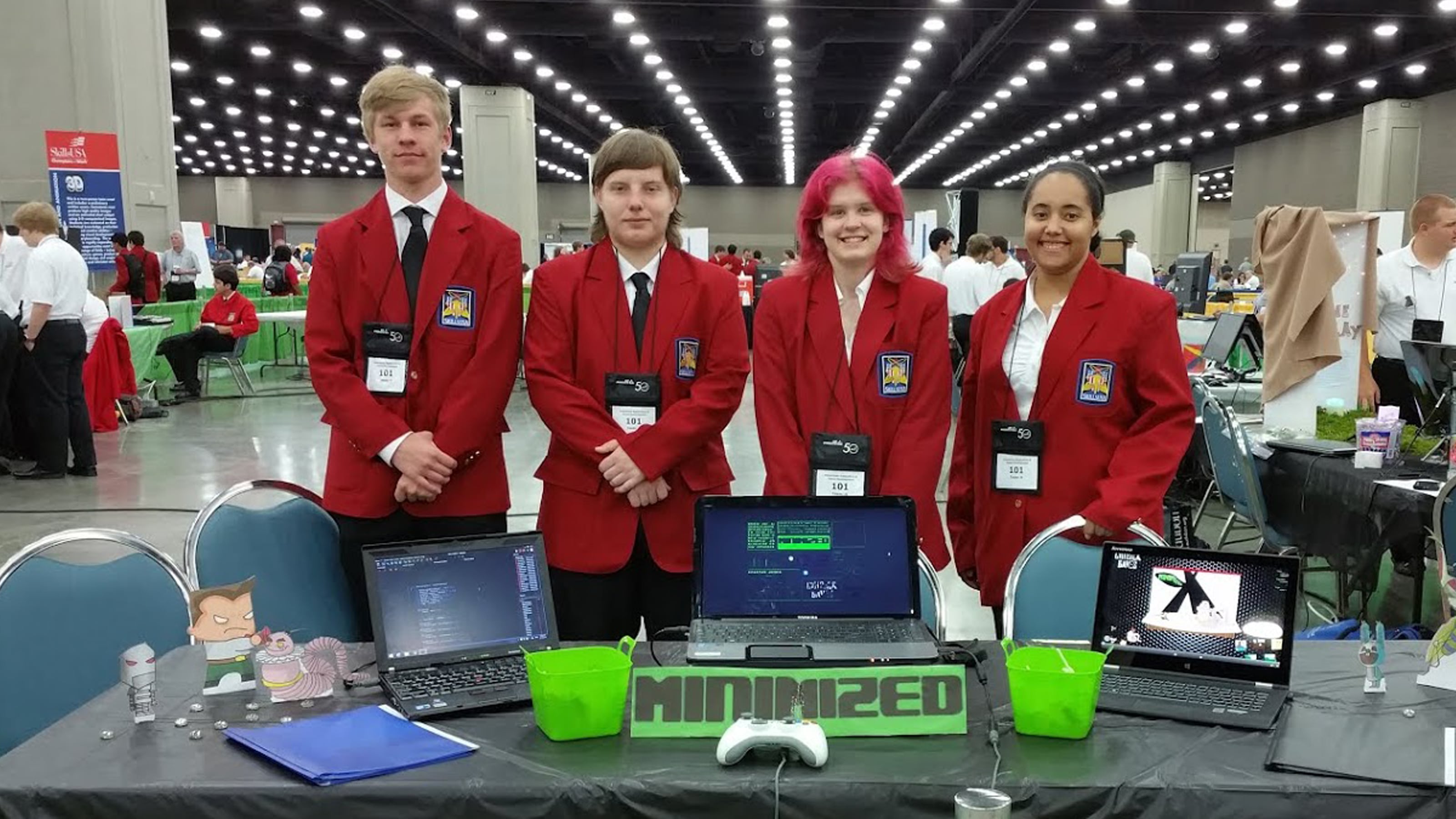 DigiPen WANIC Academy students posing in matching red jackets at their booth at the SkillsUSA competition