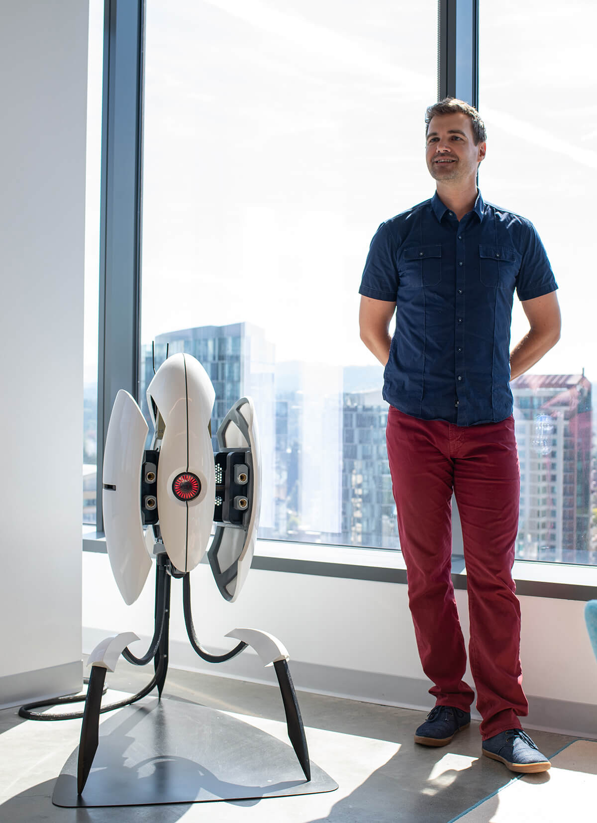 Kerry Davis stands by a replica sentry turret from the Portal video game.