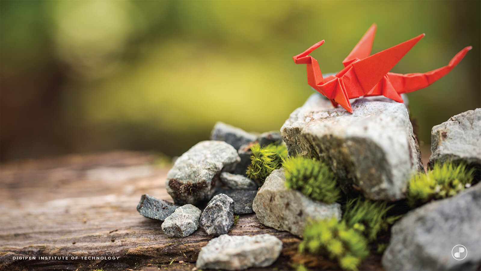A red paper origami dragon perched on a rock