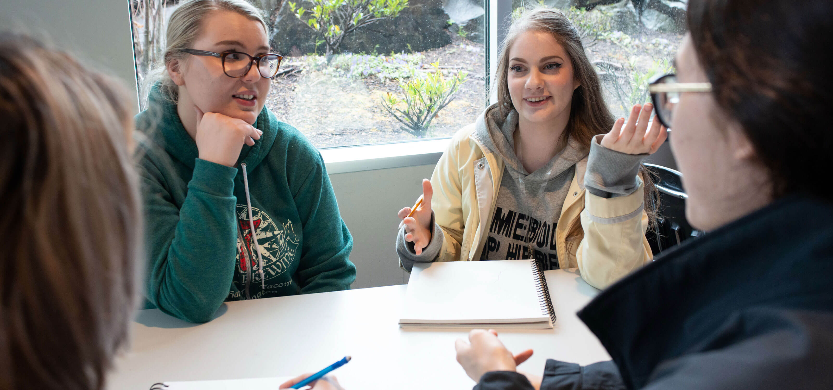 A group of DigiPen students talk in the cafe