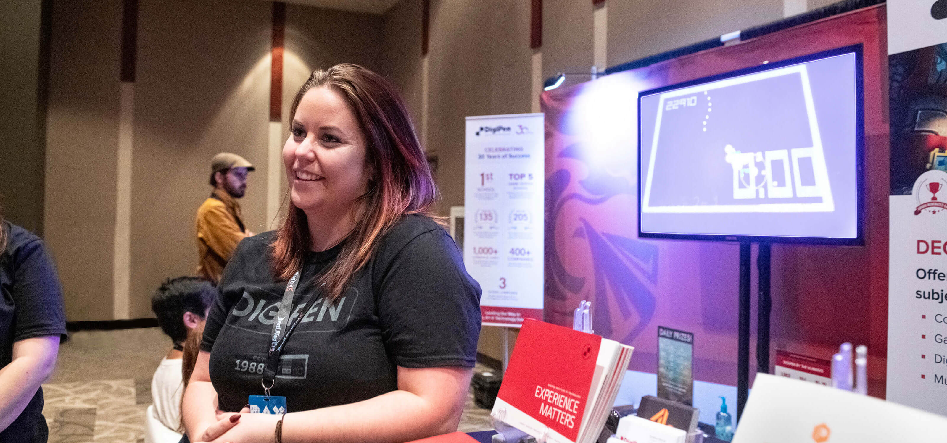 A DigiPen outreach staff member speaking to prospective students at PAX West