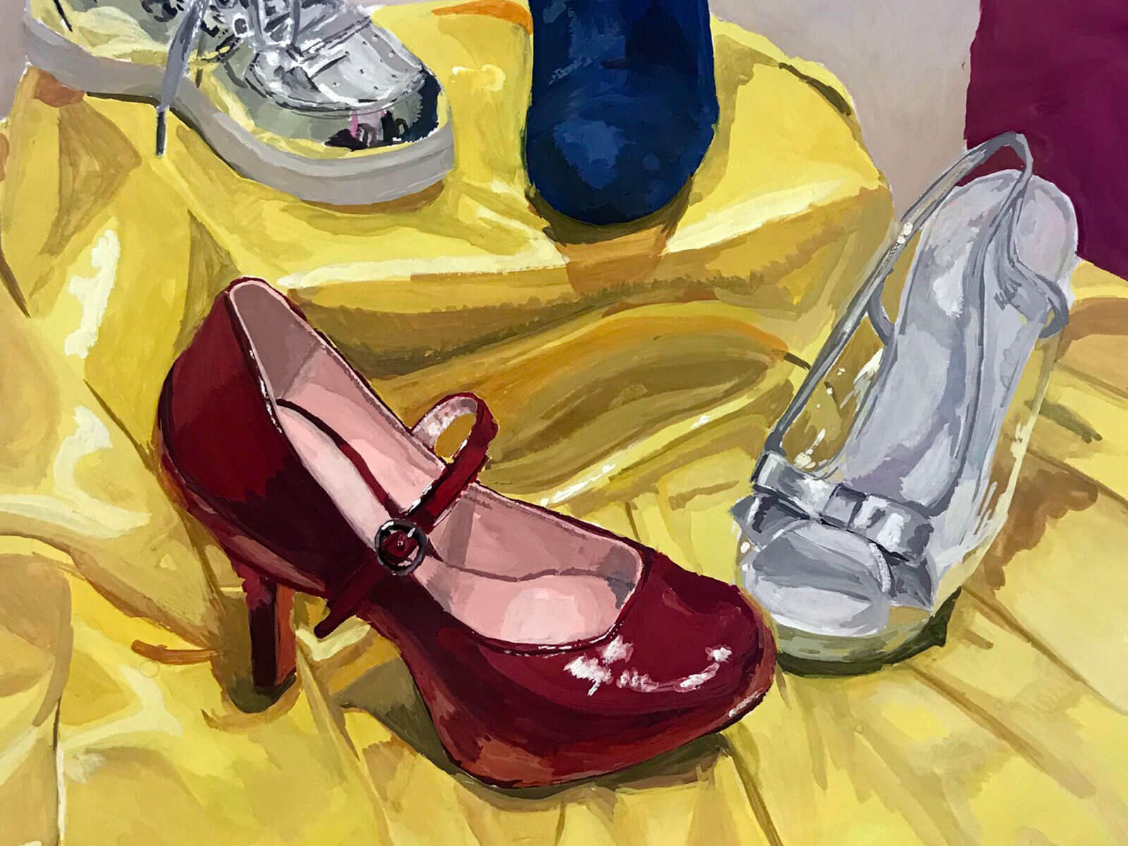 Various shoes, including high-heeled red and sliver, on a yellow cloth