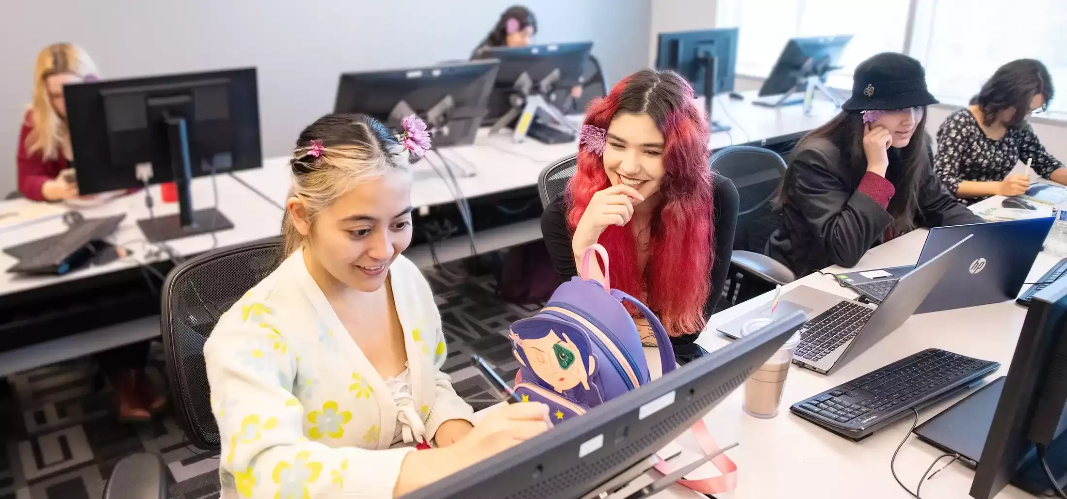 DigiPen animation students collaborate on a digital sketch pad.