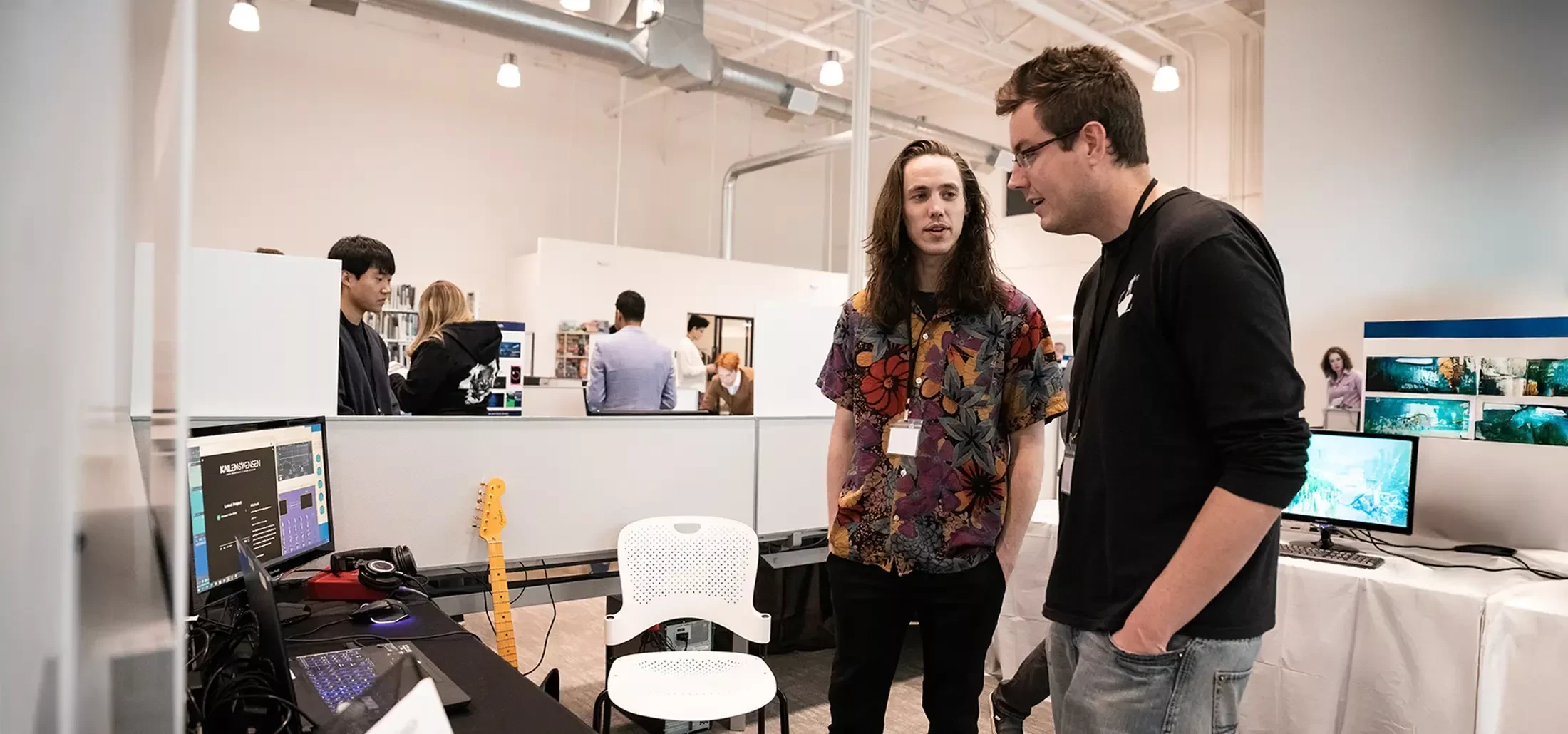 DigiPen student presents their work to a employer during a career fair.