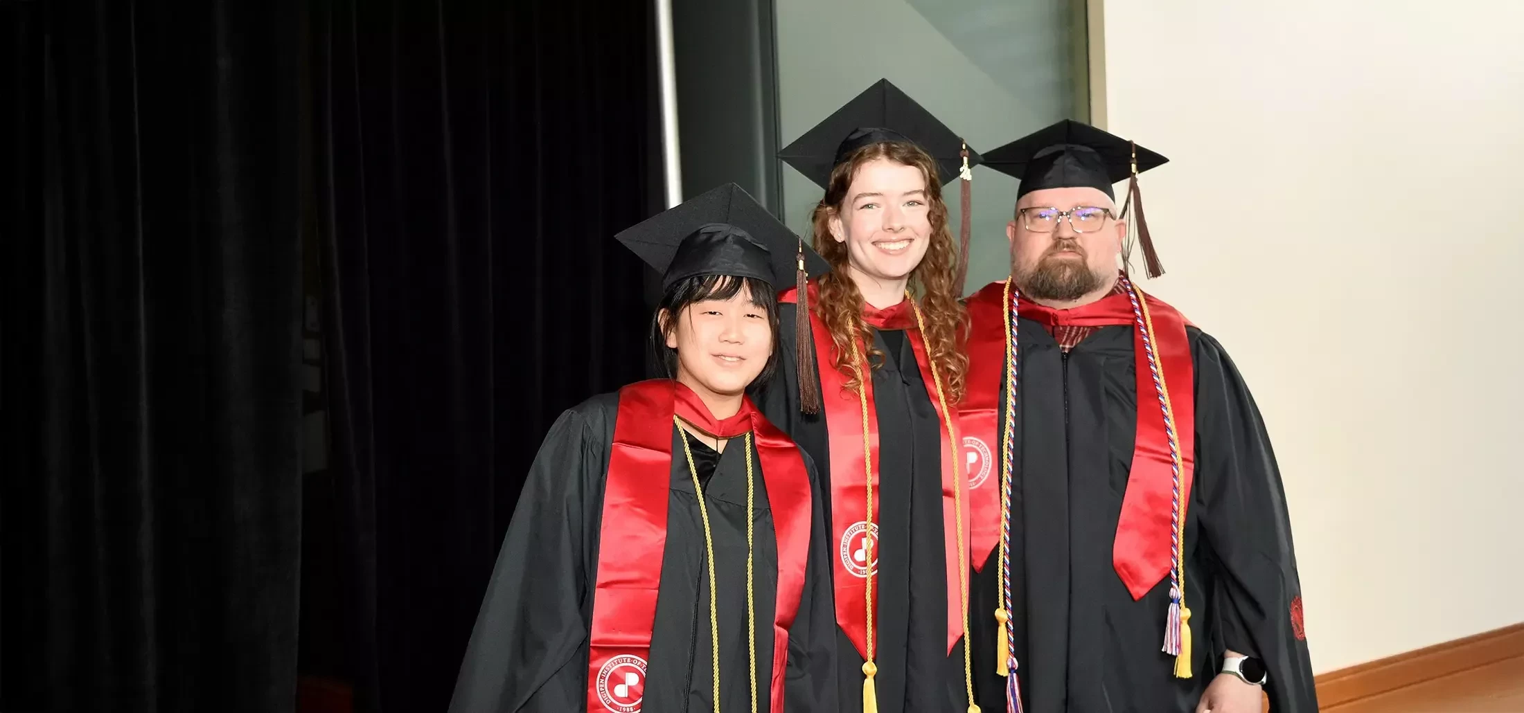 DigiPen MFA students pose in graduation robes.