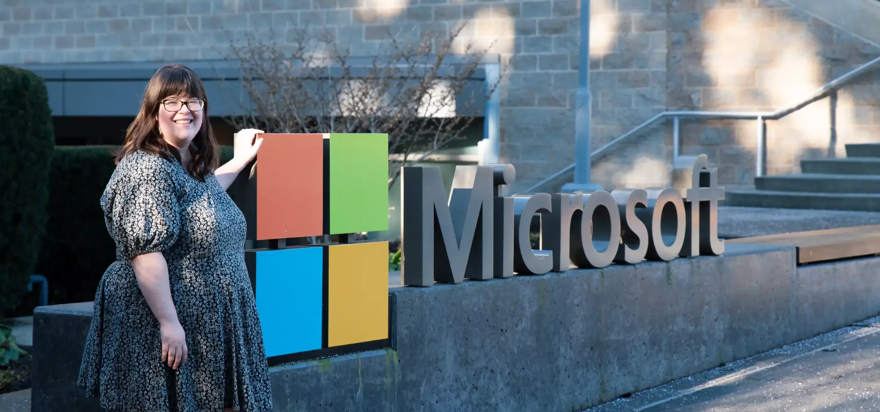 Pamela Wolf poses in front of the Microsoft logo and sign at the Redmond campus.