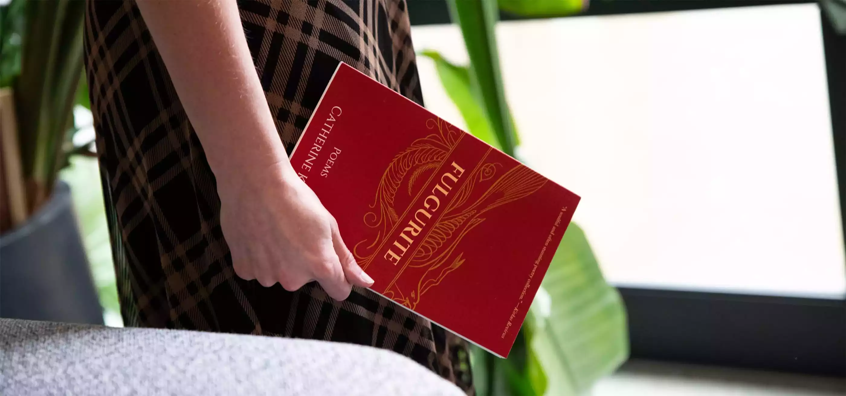 Catherine Broadwall holds a copy of her book, Fulgurite.