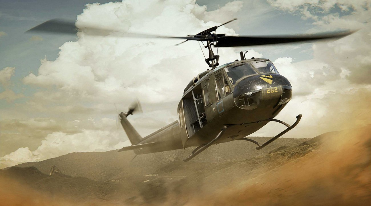 A combat helicopter swooping down in the desert.