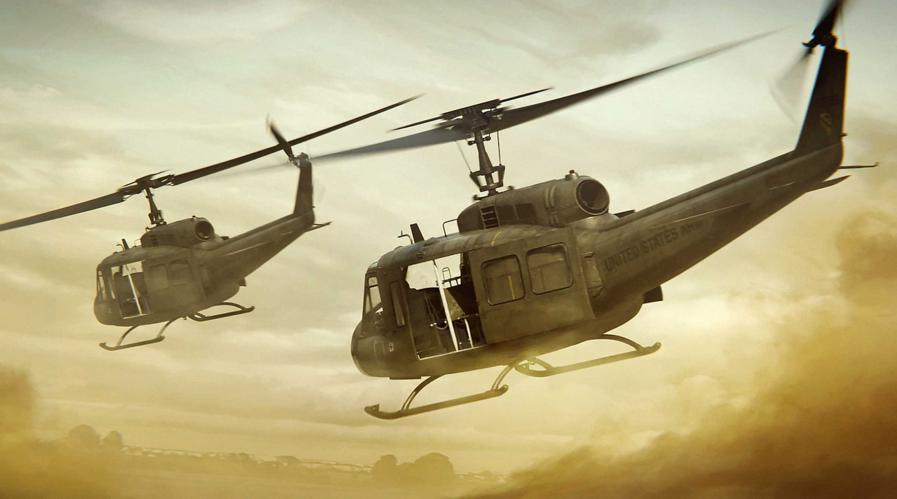 Two combat helicopters swooping down in the desert.